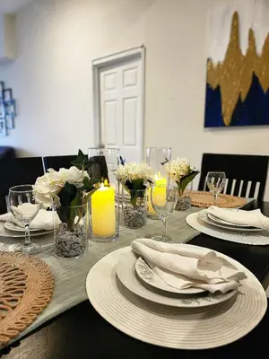 a table with plates and candles and flowers on it at Complete, Centrally-located apartment with panoramic view in San Salvador