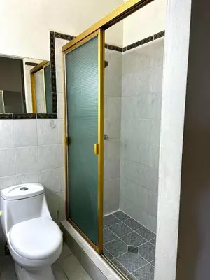 a bathroom with a toilet and a glass shower at Complete, Centrally-located apartment with panoramic view in San Salvador