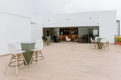 a room with a glass table and chairs in it at Cielo 404 in San Salvador