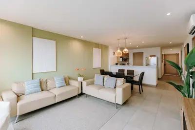 a living room with two couches and a dining room at Cielo 404 in San Salvador