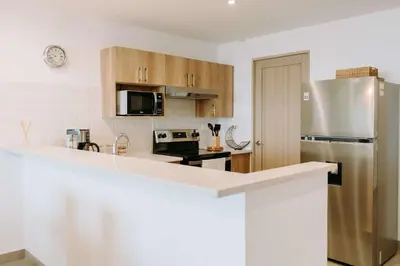 a kitchen with a white counter top and a refrigerator at Cielo 404 in San Salvador