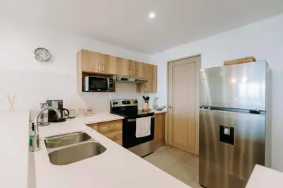 a kitchen with a stainless steel refrigerator at Cielo 404 in San Salvador