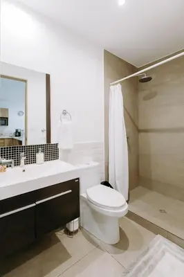 a bathroom with a white toilet and a sink at Cielo 404 in San Salvador