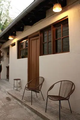 three chairs sitting outside of a building at Hostal Casa Nómada in Santa Ana