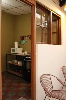 a living room with two chairs and a table at Hostal Casa Nómada in Santa Ana