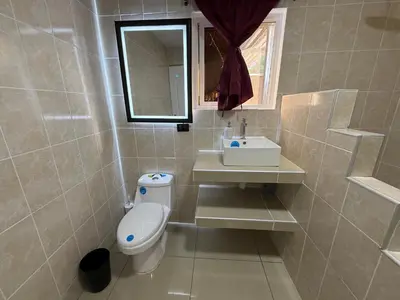a bathroom with a toilet and a sink at El Mangal 3 B&B in Suchitoto