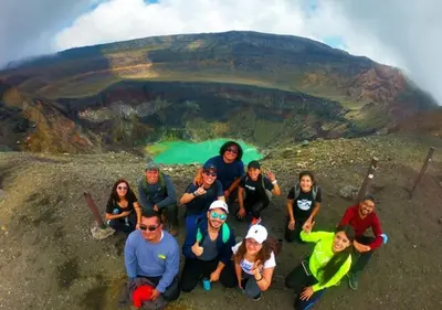 a group of people posing for a picture at the top of a mountain at \u30c4 Izalco Volcano Suites in Izalco