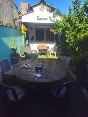 a wooden table and chairs in a yard at Casa 25 hostal santa ana in Santa Ana
