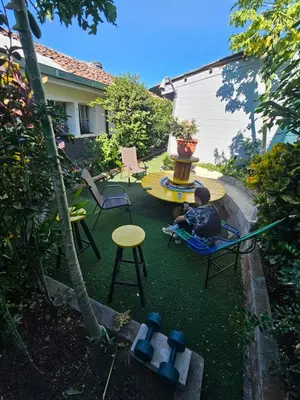 a boy sitting in a chair in a backyard at Casa 25 hostal santa ana in Santa Ana