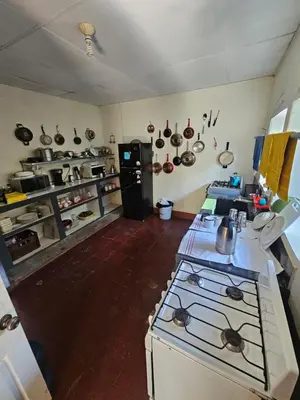 a kitchen with a stove and some pots and pans at Casa 25 hostal santa ana in Santa Ana