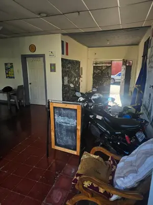 a motorcycle parked in a room with a mirror at Casa 25 hostal santa ana in Santa Ana