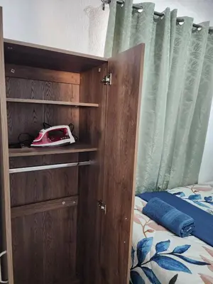 a bedroom with a bed with a wooden cabinet and a bed gmaxwell gmaxwell at Casa América in San Miguel