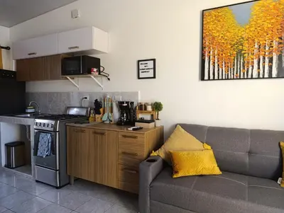 a living room with a couch and a kitchen at Casa América in San Miguel