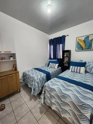 a bedroom with two beds and a dresser at Casa América in San Miguel