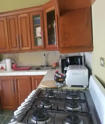 a kitchen with a stove top oven in a kitchen at Hotel Chalatenango in Nueva Concepción
