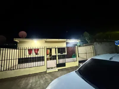 a fence in front of a building at night at Hotel Chalatenango in Nueva Concepción