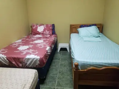 a bedroom with two beds and a small bedskirts at Hotel Chalatenango in Nueva Concepción