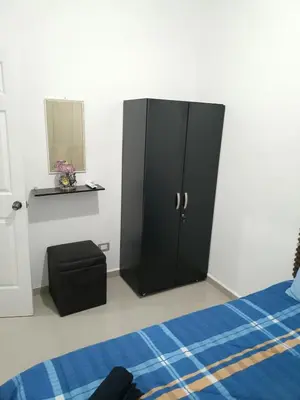 a black cabinet in a bedroom with a bed at Casa de Reyes in San Miguel