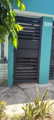 a black garage door with the number on it at La casa de Bába in San Salvador