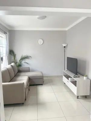 a living room with a couch and a tv at Livo house in San Salvador in San Salvador