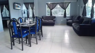 a dining room with a table and blue chairs at Apartamento Familiar 2 con 3 habitaciones 4 camas y litera in San Salvador