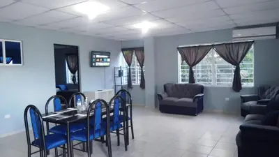 a dining room with a table and blue chairs at Apartamento Familiar 2 con 3 habitaciones 4 camas y litera in San Salvador