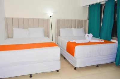 two beds sitting next to each other in a room at Hotel y Restaurante Santa Fe in La Libertad