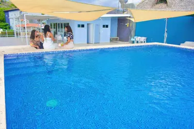 a group of women sitting next to a swimming pool at Hotel y Restaurante Santa Fe in La Libertad