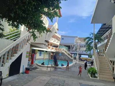 a group of people playing in a swimming pool at Hotel y Restaurante Santa Fe in La Libertad