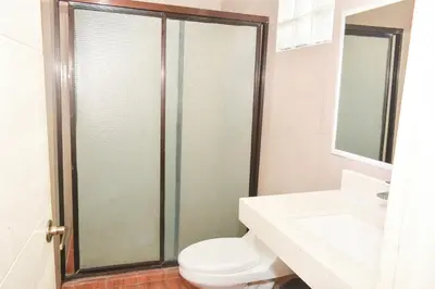 a bathroom with a shower with a toilet and a sink at Hotel y Restaurante Santa Fe in La Libertad