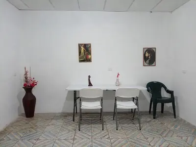 a dining room with a table and four chairs at La Chola, Guest House in Santa Ana