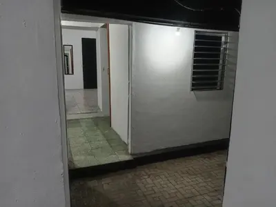 an empty hallway with a door and a window at La Chola, Guest House in Santa Ana