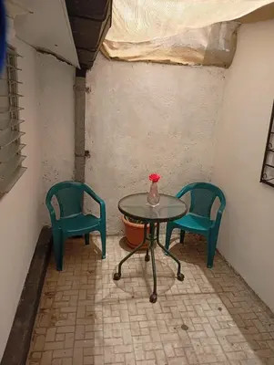 a table and two chairs in a room at La Chola, Guest House in Santa Ana