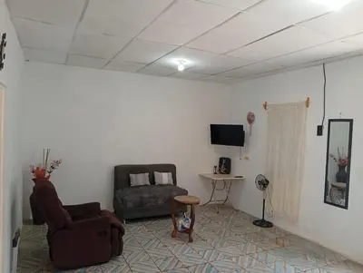 a living room with a couch and a chair at La Chola, Guest House in Santa Ana