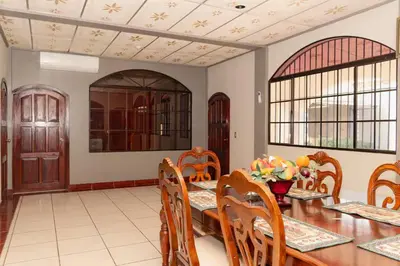 a dining room with a wooden table and chairs at Casa Familiar con Piscina y Aire Acondicionado Concepción Batres in Concepción Batres
