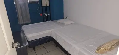 a small bed in a room with a blue wall at casa de elena in Santa Ana
