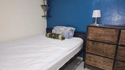 a small bedroom with a bed and a dresser at casa de elena in Santa Ana