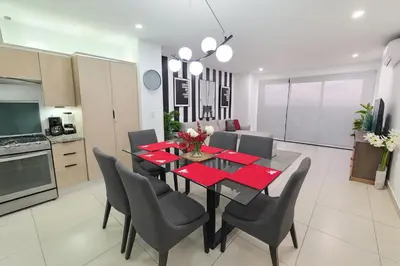 a kitchen and dining room with a table and chairs at Silvertop - A magical apartment with great view in San Salvador