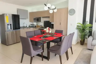 a kitchen and dining room with a table and chairs at Silvertop - A magical apartment with great view in San Salvador