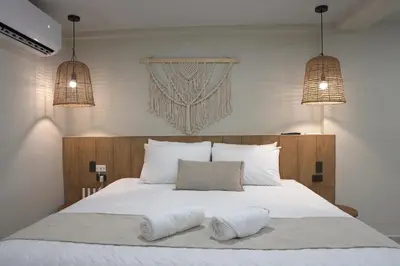 a bedroom with a bed with two pillows on it at Litos Hotel in La Libertad