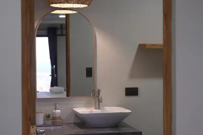 a bathroom with a sink and a mirror at Litos Hotel in La Libertad