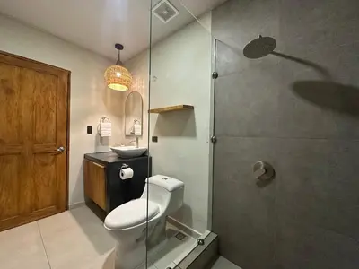 a bathroom with a toilet and a shower at Litos Hotel in La Libertad