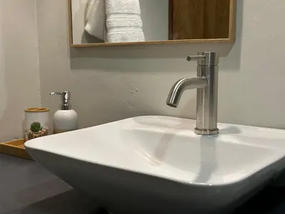 a white sink with a faucet in a bathroom at Litos Hotel in La Libertad