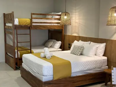 a bedroom with two bunk beds and a ladder at Litos Hotel in La Libertad