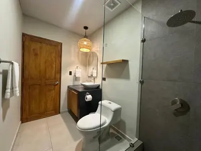 a bathroom with a toilet and a sink and a shower at Litos Hotel in La Libertad