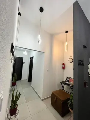 a living room with white walls and potted plants at Home Sweet Home at Opico Garden in San Juan Opico