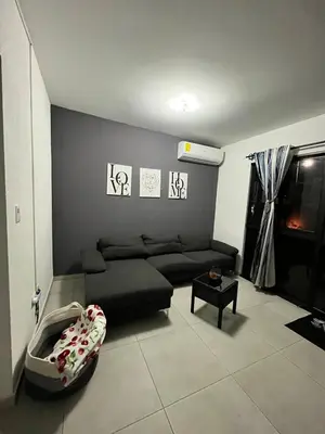 a living room with a couch and a table at Home Sweet Home at Opico Garden in San Juan Opico