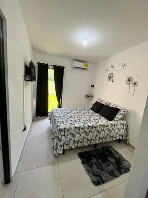 a small bedroom with a bed and a window at Home Sweet Home at Opico Garden in San Juan Opico