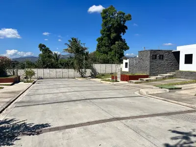 an empty parking lot in front of a building at Home Sweet Home at Opico Garden in San Juan Opico