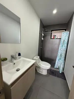 a bathroom with a white sink and a toilet at Escalon apartment in San Salvador